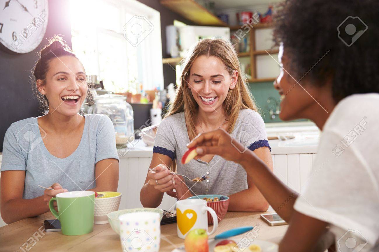 41146947-three-female-friends-enjoying-breakfast-at-home-together